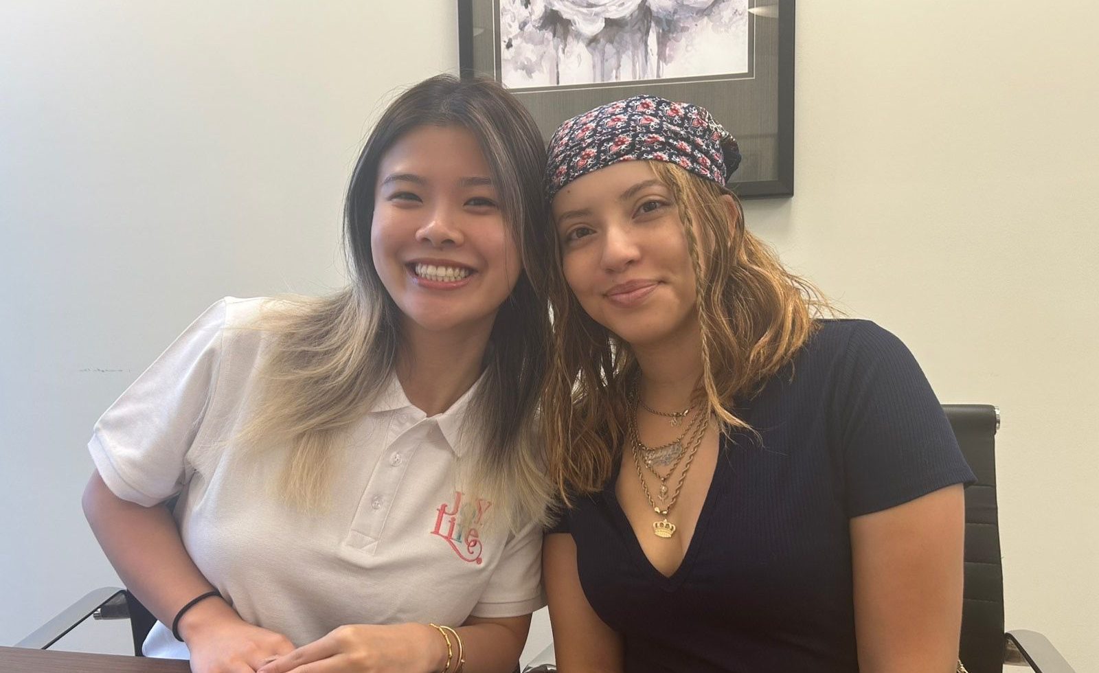 Joy of Life Surrogacy team member smiling with a surrogate during an in-office consultation, representing compassion and connection in the surrogacy journey.